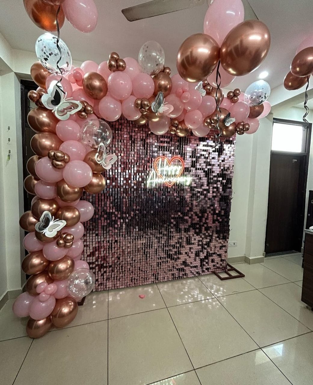 Anniversary balloon decoration in rose gold with shimmer wall backdrop