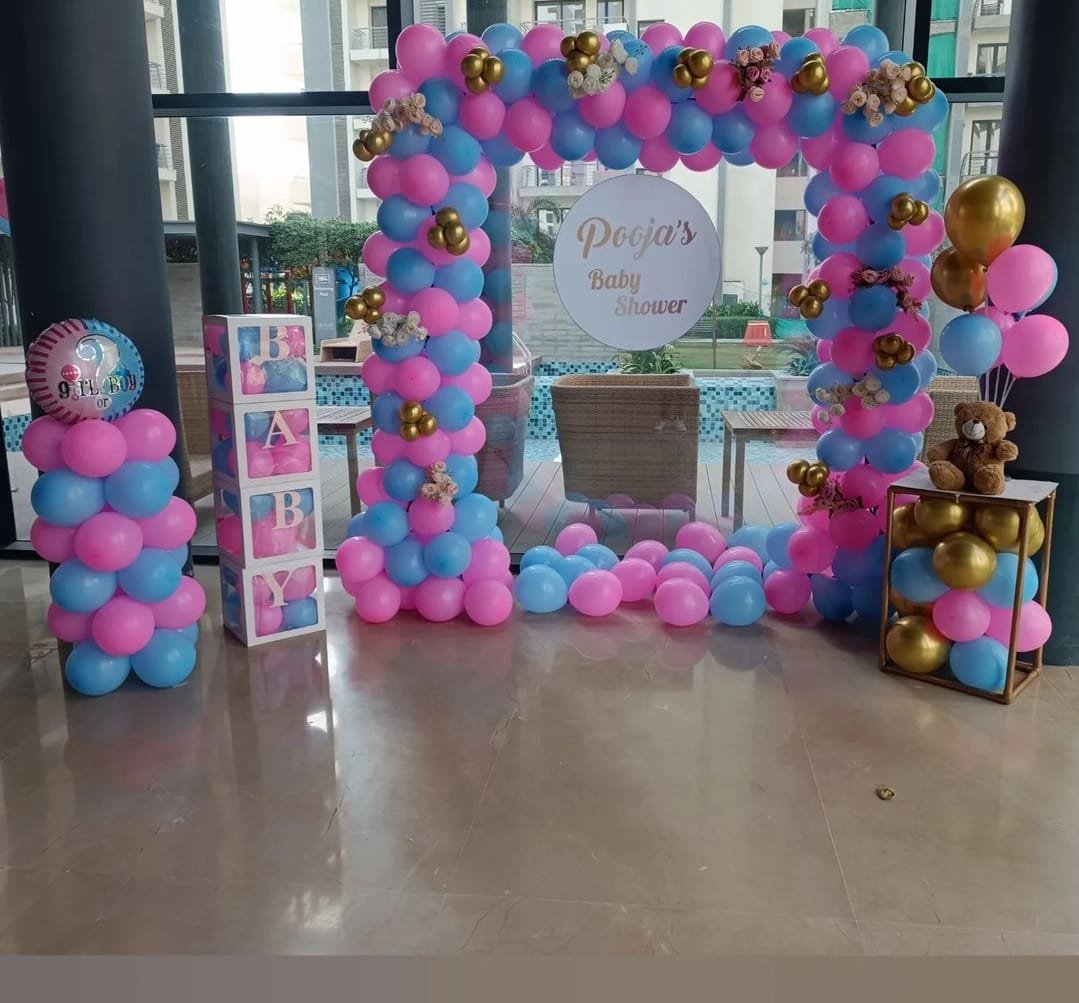 Baby shower balloon arch in pink and blue with custom name board