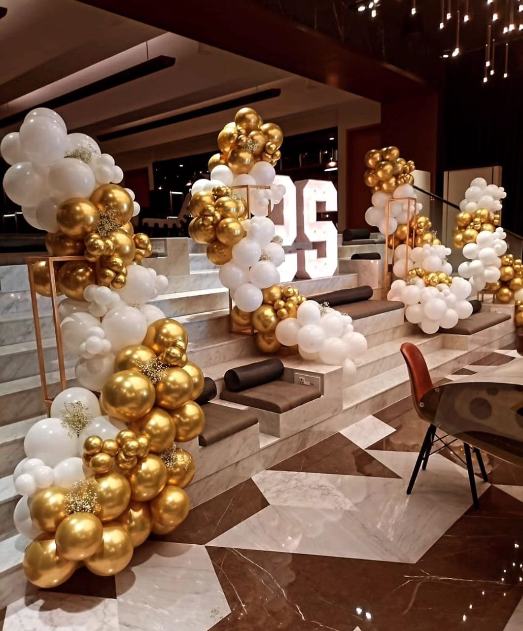 Corporate event balloon decoration in white and gold at a luxury venue