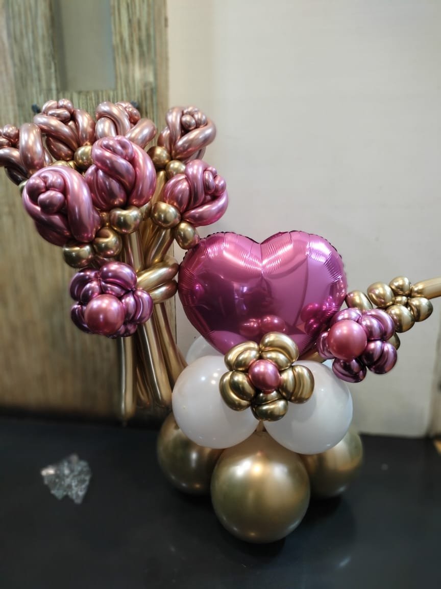 Proposal decor with pink heart foil balloon and chrome balloon flowers